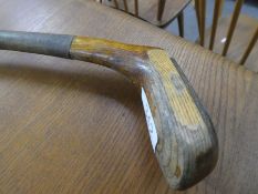 An old hickory shafted putter, having wooden head