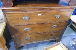 An antique mahogany chest having 3 long drawers with brushing slide