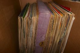 A box of vinyl LPs and singles