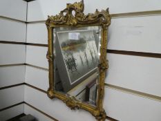 A Georgian mahogany wall mirror having carved decoration and two other gilt wall mirrors