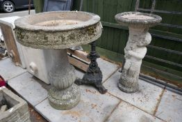 A large reconstituted bird bath, one other and a cast iron pub table base