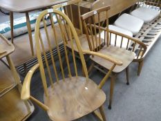 Ercol, a stickback rocking chair having open arms and a pair of kitchen chairs