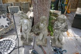 Two similar garden statues of boys and a semi nude lady statue