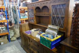 A reproduction Oak dresser, having 3 central drawers with partially glazed rack back