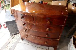 An antique mahogany bow front chest of drawers and an armchair, (no cushions)