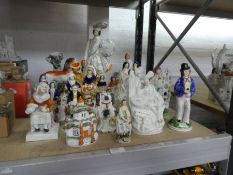 A quantity of Staffordshire figures and spill vases