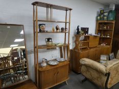 Ercol, an elm room divider having open shelves with cupboard base