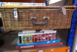 A wicker picnic basket, books and sundry