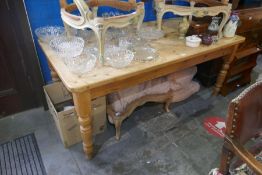 A modern pine oblong kitchen table on turned legs