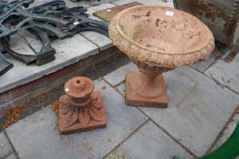A terracotta garden urn and one other base