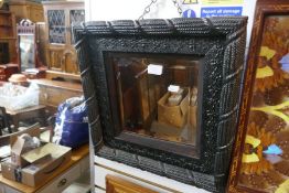 An old mirror having rope style frame and a butterfly tray