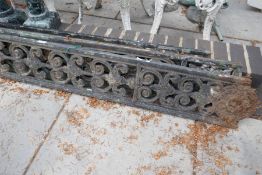 Three Victorian cast iron veranda supports having scroll decoration, (one damaged)