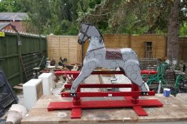 A grey painted rocking horse and a pine rackback