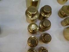 A quantity of old brass weights and similar, some with money denominations