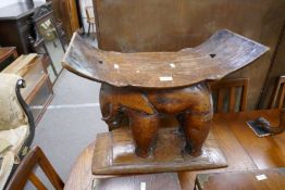 An African Ashante carved hardwood elephant stool with a rectangular dished top, early 20th century,