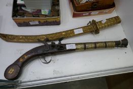 A brass oriental style sword and a reproduction Middle Eastern flintlock pistol
