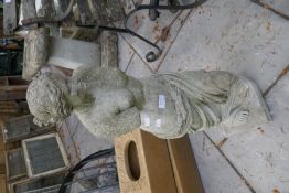 A garden statue of semi nude lady