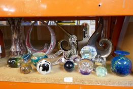 A selection of glassware including paperweights, vases and abstract art