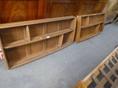 Two similar Ercol hanging wall shelves, having panel backs, width 107cm