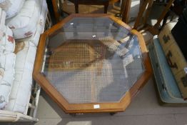 A modern octagonal coffee table having glass inset top