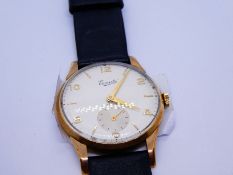 A 9ct gold Everite 15 jewels wristwatch with a genuine leather black strap