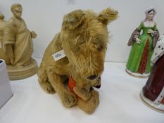An antique Steiff sitting, tail turns, head rattler Terrier dog and one other miniature antique bear