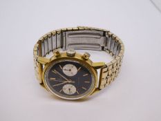 Vintage gents gold plated Breitling Geneve 'Top Time' wristwatch with black dial and gold hands, gla