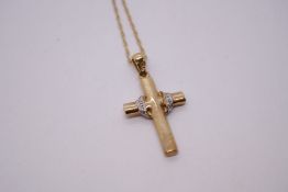 9ct yellow gold neckchain hung with a 9ct gold cross inset with diamond chips, 3.8g approx, marked 3