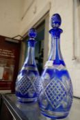 A pair of Bohemian blue and clear glass decanters