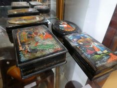 Four Russian lacquer boxes, having painted panels