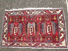 An old part silk rug, having 4 central panels and 2 other rugs, the largest 125 x 86cm