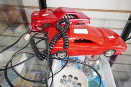 Two Betacom telephones in the form of Mercedes and Ferarri motor cars