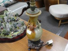 A carved soapstone table, lamp on soapstone base