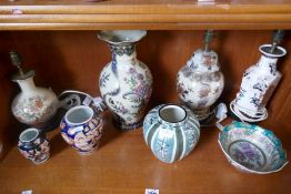 A shelf of vases, lamps and similar