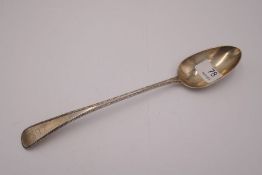 A Georgian silver heavy serving spoon with beaded border and lion engraved. Hallmarked London 1805,
