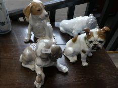 A Lladro model of dog with snail, a Royal Copenhagen seated puppy and two other dog figures