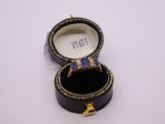 Antique Sapphire and diamond ring with central oval blue sapphire flanked diamonds and smaller oval