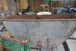 An old galvanised trough of semi circle form