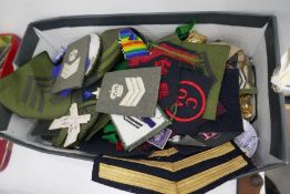 A small quantity of Military badges, cloth badges and similar
