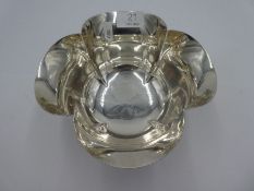 An impressive, heavy silver Victorian fruit bowl in a petal formed design having beaded rim on four