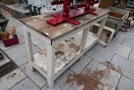 A two tier work bench with painted base