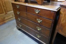 An antique mahogany chest having two short and three long drawers, on bracket feet