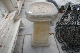 A large reconstituted stone bird bath on square base