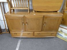 Ercol, an Elm sideboard having cupboards with 2 drawers below, 129cm