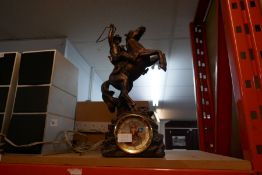 A bronze style John Wayne clock with figure of cowboy on rearing horse