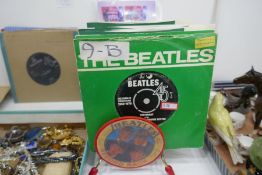 A 1960s record rack, 7 Beatles singles and others