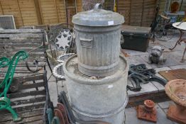 An old galvanised barrel and a small bin
