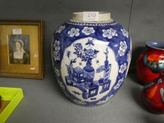 A 19th century Chinese blue and white ginger jar, the panels decorated flowers, furniture and vases,