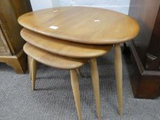 A nest of three Ercol pebble shaped coffee tables