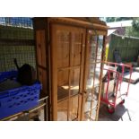 A modern pine display cabinet having 2 doors